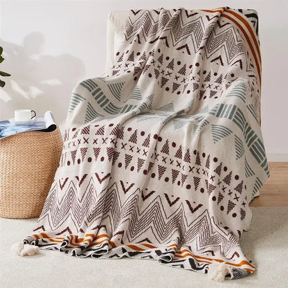 Bohemian Patterned blanket draped over a chair with a neutral background