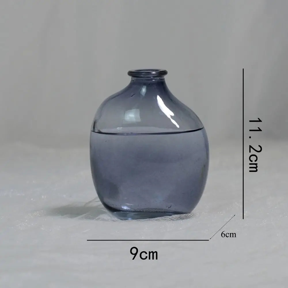 Blue glass vase with measurements on a gray background