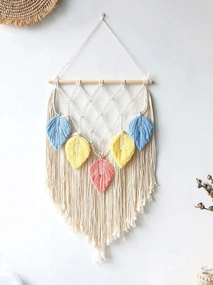 Macrame wall hanging with colorful leaf-shaped decorations on a white background. boho macrame