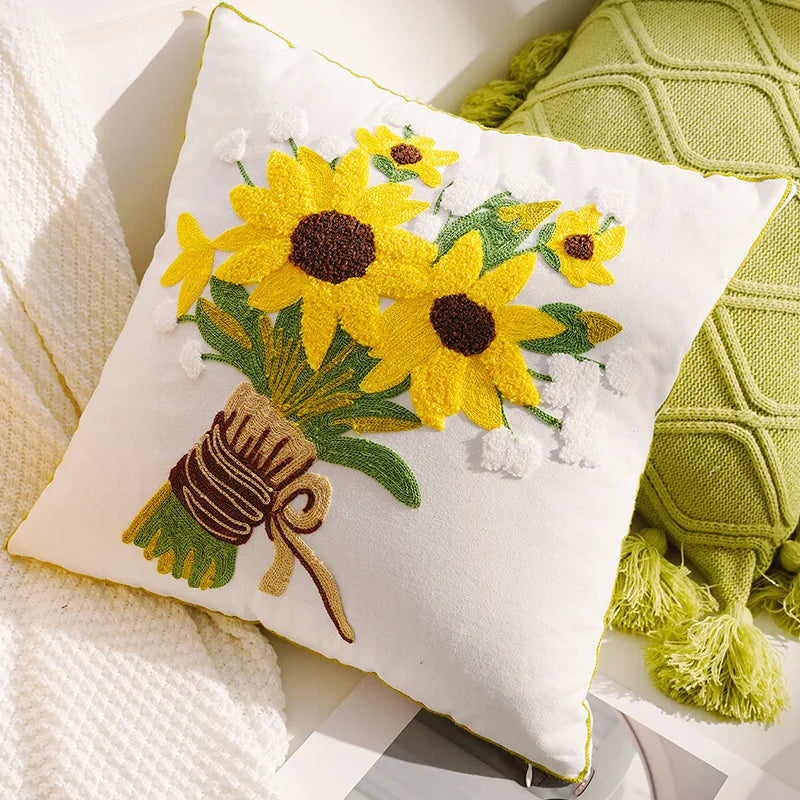 Decorative pillow with embroidered sunflowers and a bee on a soft fabric background