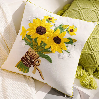 Decorative pillow with embroidered sunflowers and a bee on a soft fabric background