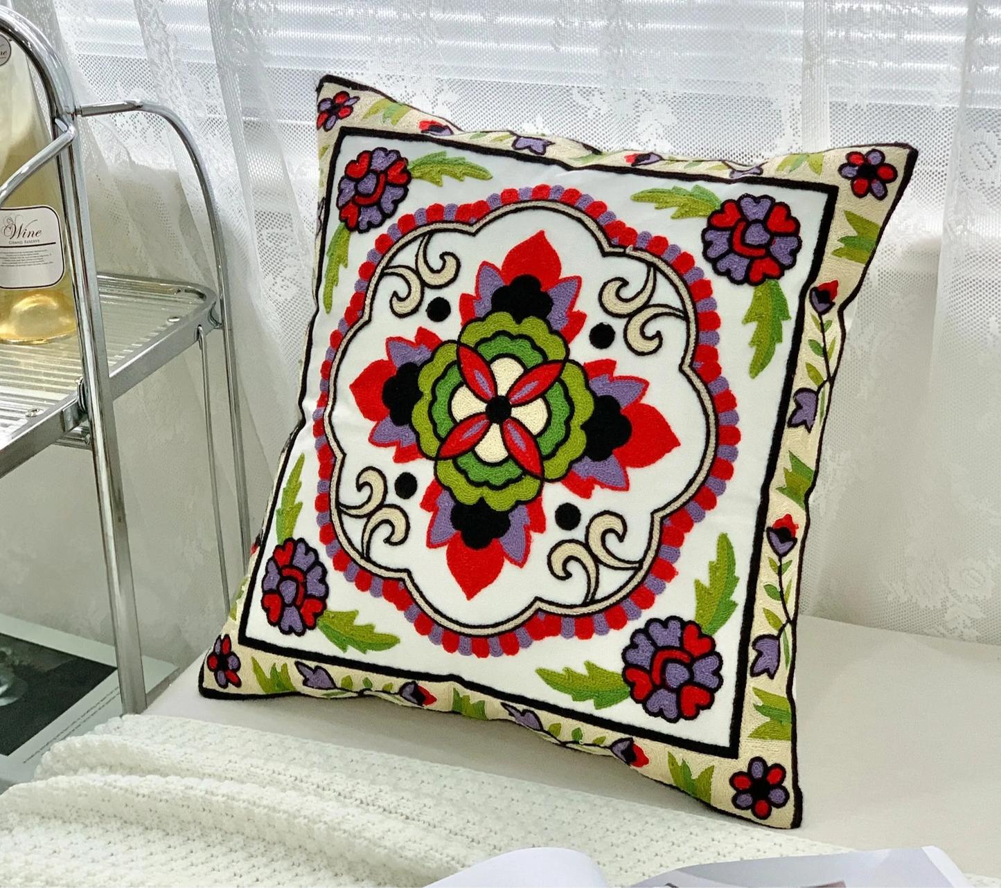 Decorative pillow with colorful floral pattern on a white surface, floral embroidery on linen cotton cushion cover – boho home decor accent