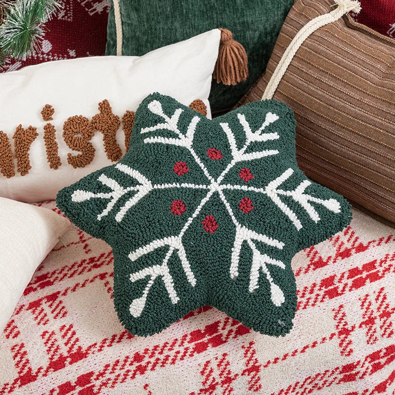 Decorative star pillow with snowflake pattern on a textured fabric background
