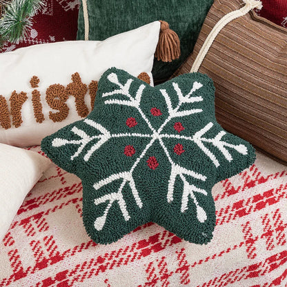 Decorative star pillow with snowflake pattern on a textured fabric background