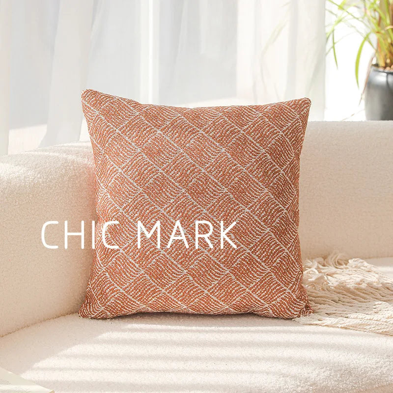 Decorative pillow with 'CHIC MARK' text on a beige couch. Modern yarn-dyed throw pillow cover, luxury textured decorative cushion for sofa, bed, or window seating in soft neutral tones.
