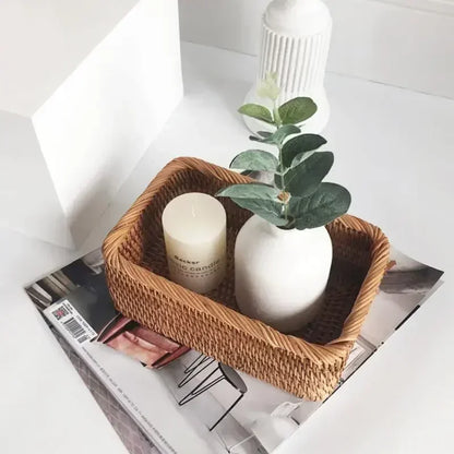 Wicker basket with a candle and vase on top of a magazine boho home decor, rattan basket, handwoven wicker basket, fruit storage box, bread basket, picnic basket, natural storage bin, tea storage box, rustic home organization, farmhouse decor, housewarming gift, boho storage basket