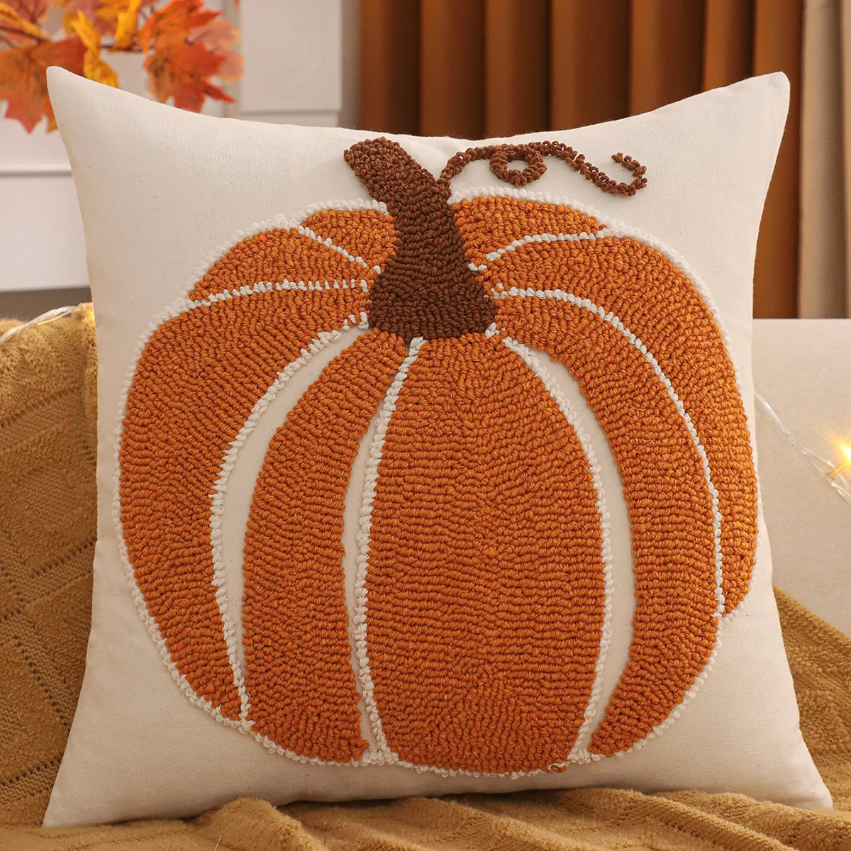 Decorative pillow with a pumpkin design on a couch. Tufted Halloween pumpkin pillow cover autumn decorative cushion