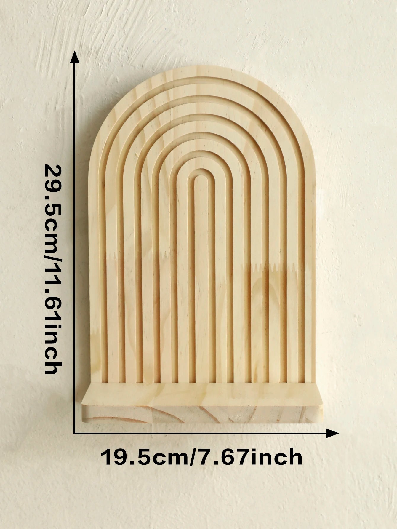 Wooden arch-shaped decorative item with measurements on a beige background