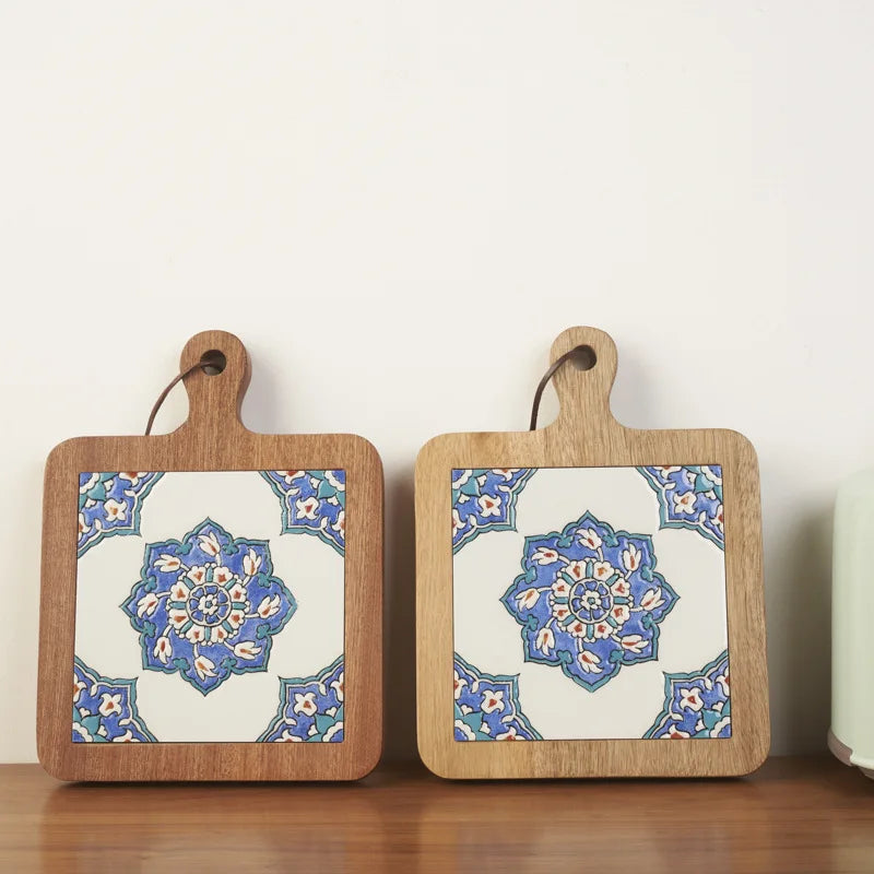 Two wooden cutting boards with decorative blue and white patterns on a light background