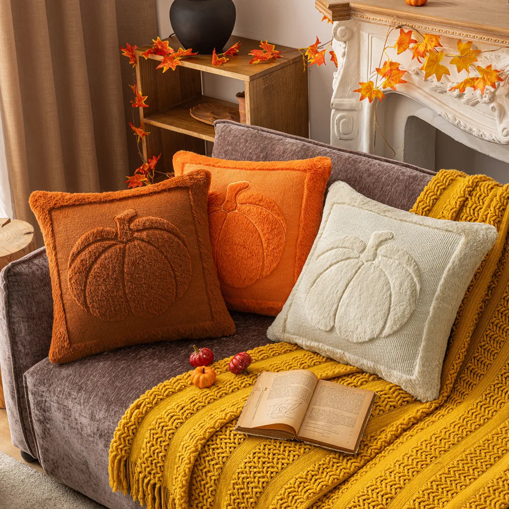 Cozy living room with a sofa adorned with pumpkin-themed pillows and a yellow blanket. Halloween pumpkin plush pillow cover for sofa and bed decor.