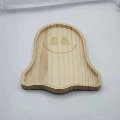 Wooden ghost-shaped tray on a white background. Wooden Halloween serving tray in pumpkin and ghost shapes, rustic snack and dessert plate for party décor and fall entertaining