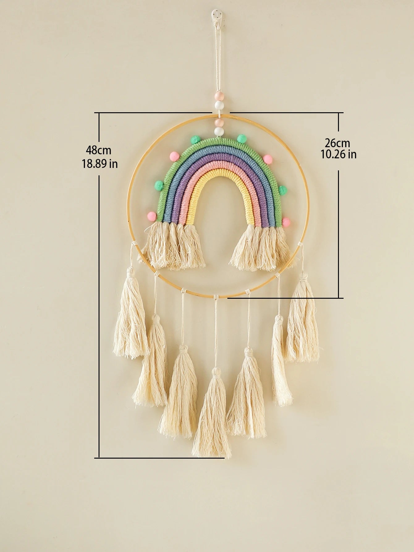 Decorative rainbow wall hanging with tassels and measurements on a beige background. Handmade macrame rainbow wall hanging boho home decor