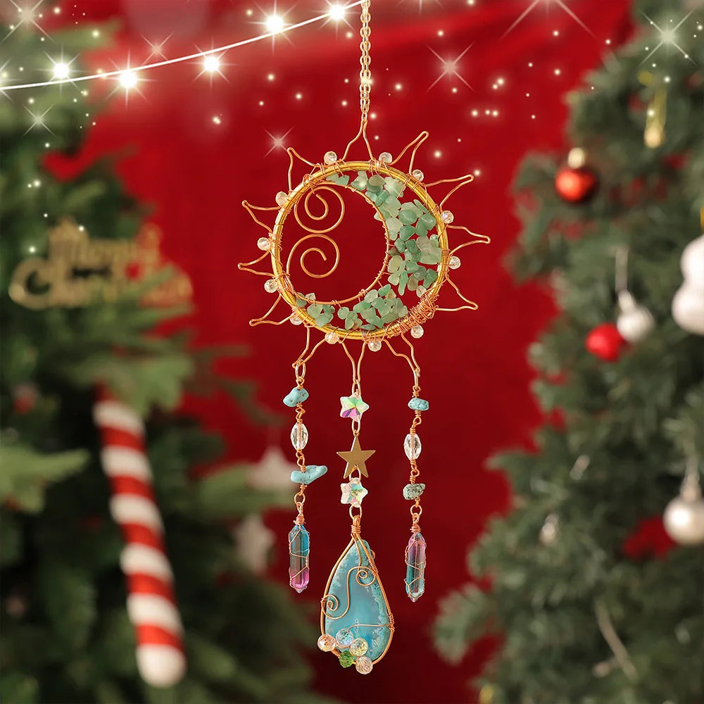 Decorative sun-shaped ornament with beads hanging against a festive background with Christmas trees. boho home decor, crystal wind chime, sun catcher for windows, moon prism chime, agate stone hanging, garden art decor, patio hanging decoration, boho housewarming gift, spiritual gift, crystal suncatcher, balcony decor, meditation decor, handmade crystal chime