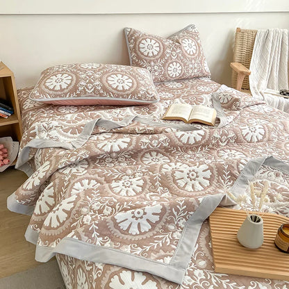 Bed with patterned bedding and pillows in a bedroom setting. Boho breathable lightweight summer spring fall blanket quilt bedspread 