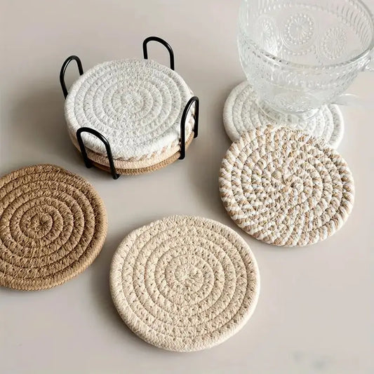 Flat lay of 8 round cotton woven coasters in neutral tones on a wooden table – minimalist boho home decor