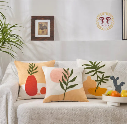 Decorative pillows with plant designs on a sofa in a living room setting.