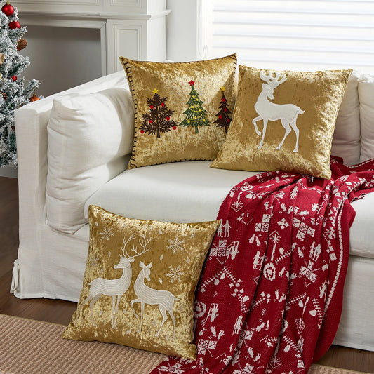 Decorative pillows with Christmas designs on a white couch with a red blanket. Christmas embroidered pillow cover in gold, 18x18 inch festive cushion case for sofa, bed, or holiday home décor. Christmas Gift Ideas