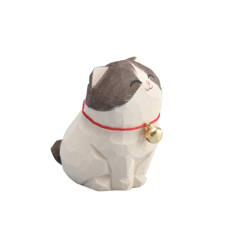 Cat-shaped plush toy with a red collar and gold bell on a white background