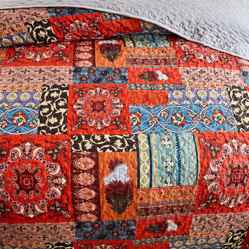 Colorful patchwork quilt with intricate patterns on a white background. Lightweight boho quilted bedspread set with pillow shams, soft all-season coverlet for queen, king, full, or twin beds in modern cloud pattern design.