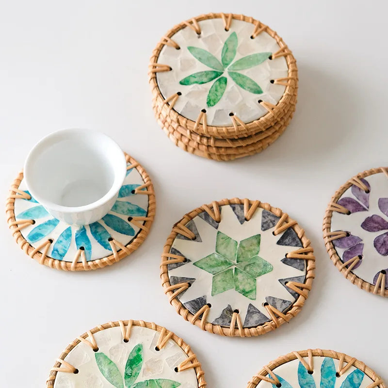 Set of boho decorative coasters with floral shell patterns on a white surface