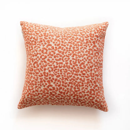 Cushion with orange leopard print pattern on a white background