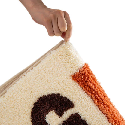 Hand lifting a corner of a colorful rug with geometric pattern on a white background boho home decor, bathroom rug, tufted bath mat, Get Naked rug, colorful shower mat, apartment decor, dorm bathroom accessories, housewarming gift, microfiber bath mat, fun bathroom rug, American style bath mat
