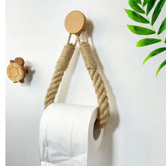 Wall-mounted toilet paper holder with wooden top and jute rope, white wall background. Boho rope toilet paper holder, nail-free wall mounted paper towel rack, rustic bathroom storage and decor accessory with wood and rope design