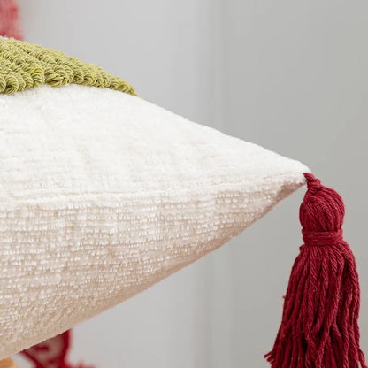 Textured pillow with a red tassel on a neutral background