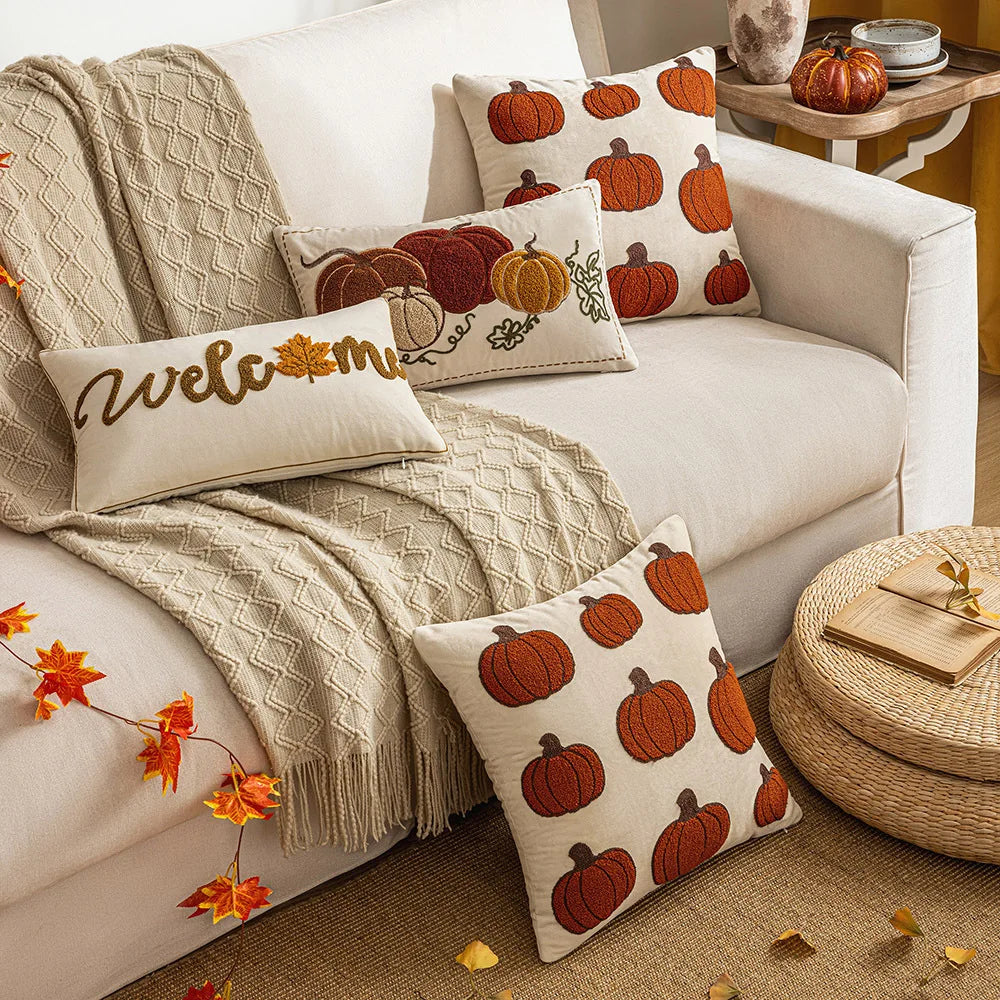 Cozy living room with a white sofa adorned with pumpkin-patterned pillows and a 'welcome' pillow. Autumn velvet embroidered pumpkin pillow cover, Nordic-style decorative cushion for sofa, bed, and fall boho home decor
