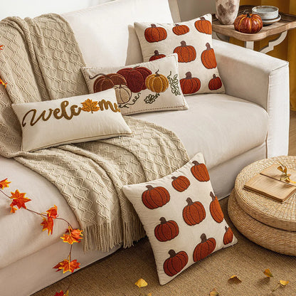 Cozy living room with a white sofa adorned with pumpkin-patterned pillows and a 'welcome' pillow. Autumn velvet embroidered pumpkin pillow cover, Nordic-style decorative cushion for sofa, bed, and fall boho home decor