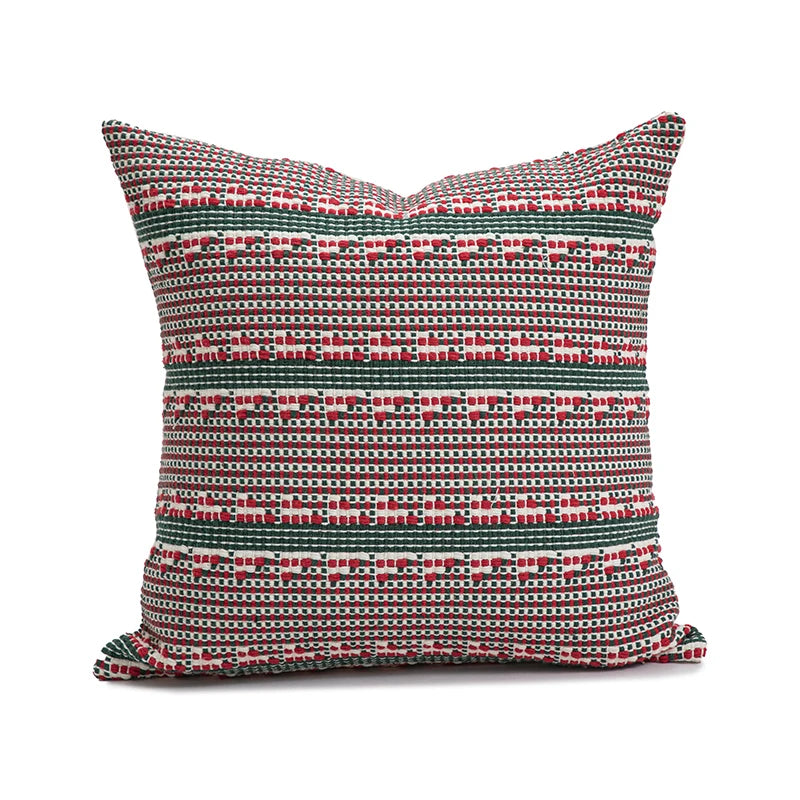 Decorative pillow with a red and green pattern on a white background