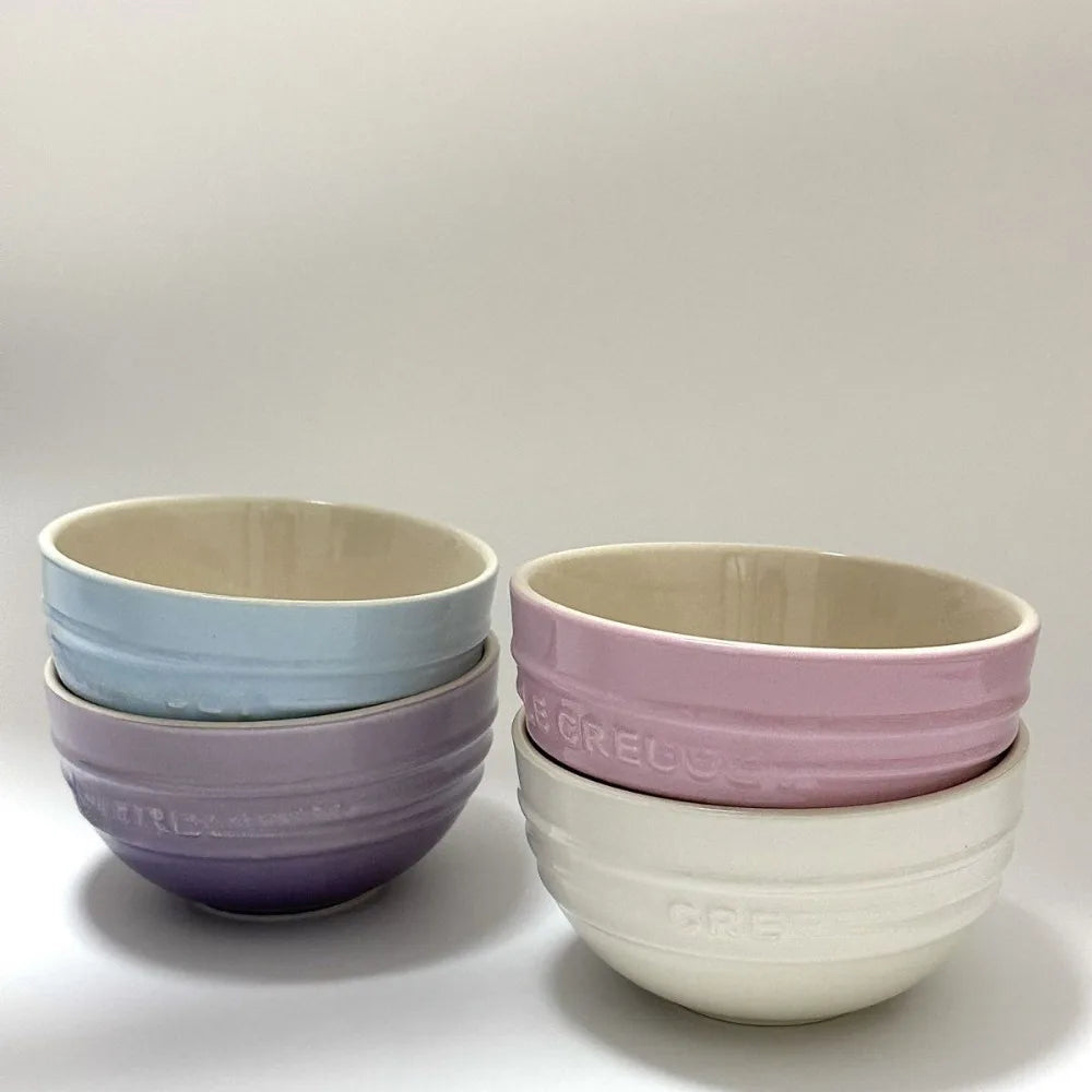 Set of ceramic bowls in pastel colors on a light gray background Gradient ceramic rice bowl in bright colors, bone china soup and noodle bowl, dessert and pudding kitchen tableware for boho home dining