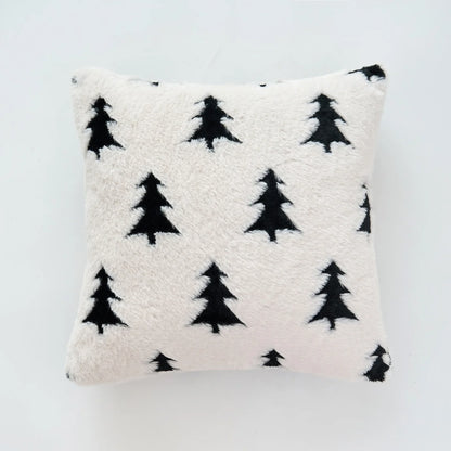 White pillow with black tree pattern on a light gray background