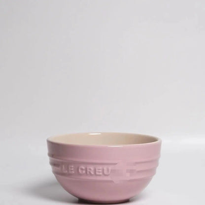 Pink mixing bowl with 'Le Creuset' branding on a light gray background Gradient ceramic rice bowl in bright colors, bone china soup and noodle bowl, dessert and pudding kitchen tableware for boho home dining