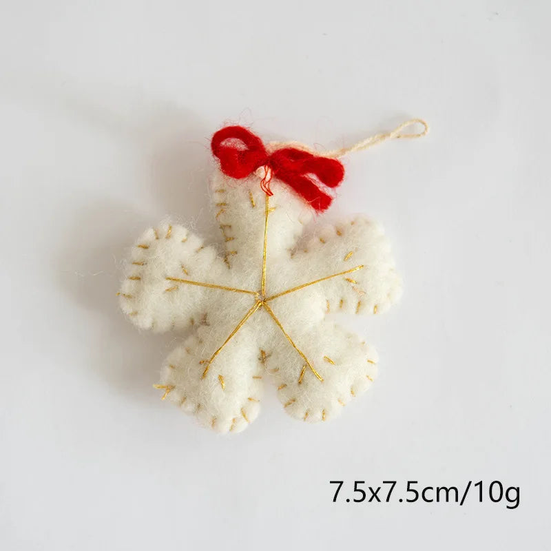 White felt star ornament with a red bow on a light gray background