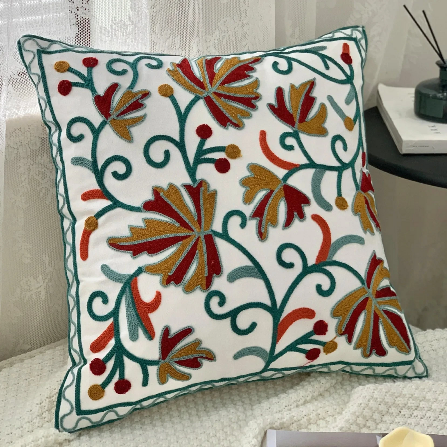 Decorative pillow with floral patterns on a couch, Handcrafted embroidered cushion cover on armchair – modern boho living room decor