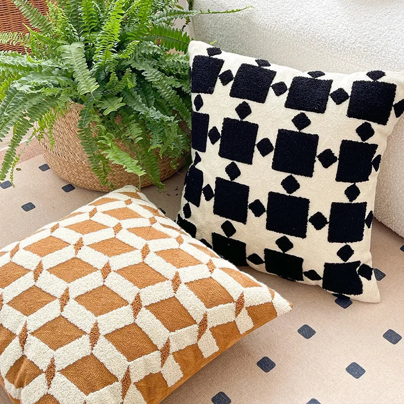 Two patterned pillows on a couch with a plant in the background. Bohemian embroidered throw pillow cover 18x18 inch with geometric towel embroidery, decorative cushion for sofa, bed, or living room boho home decor