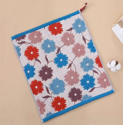 Floral patterned tea towel with red, blue, and pink flowers on a beige background