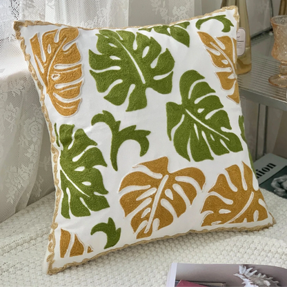 Decorative pillow with leaf pattern on a couch, Handcrafted embroidered cushion cover on armchair – modern boho living room decor