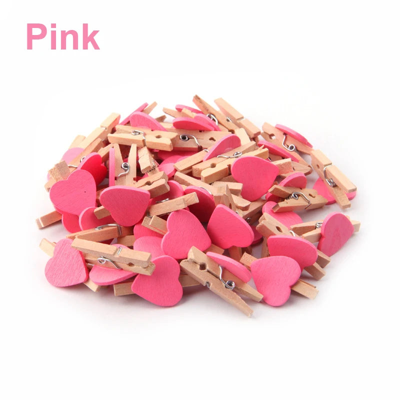 Pink heart-shaped clothespins on a white background
