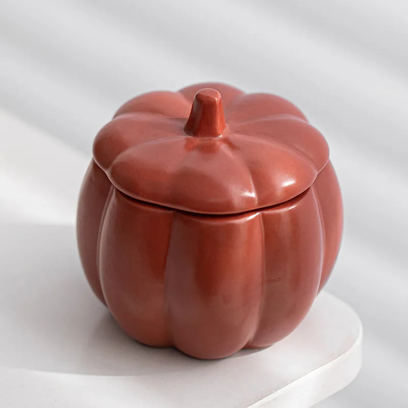 Ceramic pumpkin-shaped container on a white background. fall home decor