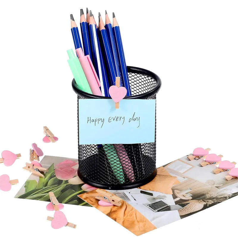 Black mesh pencil holder with stationery items on a white background