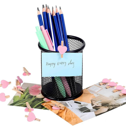 Black mesh pencil holder with stationery items on a white background