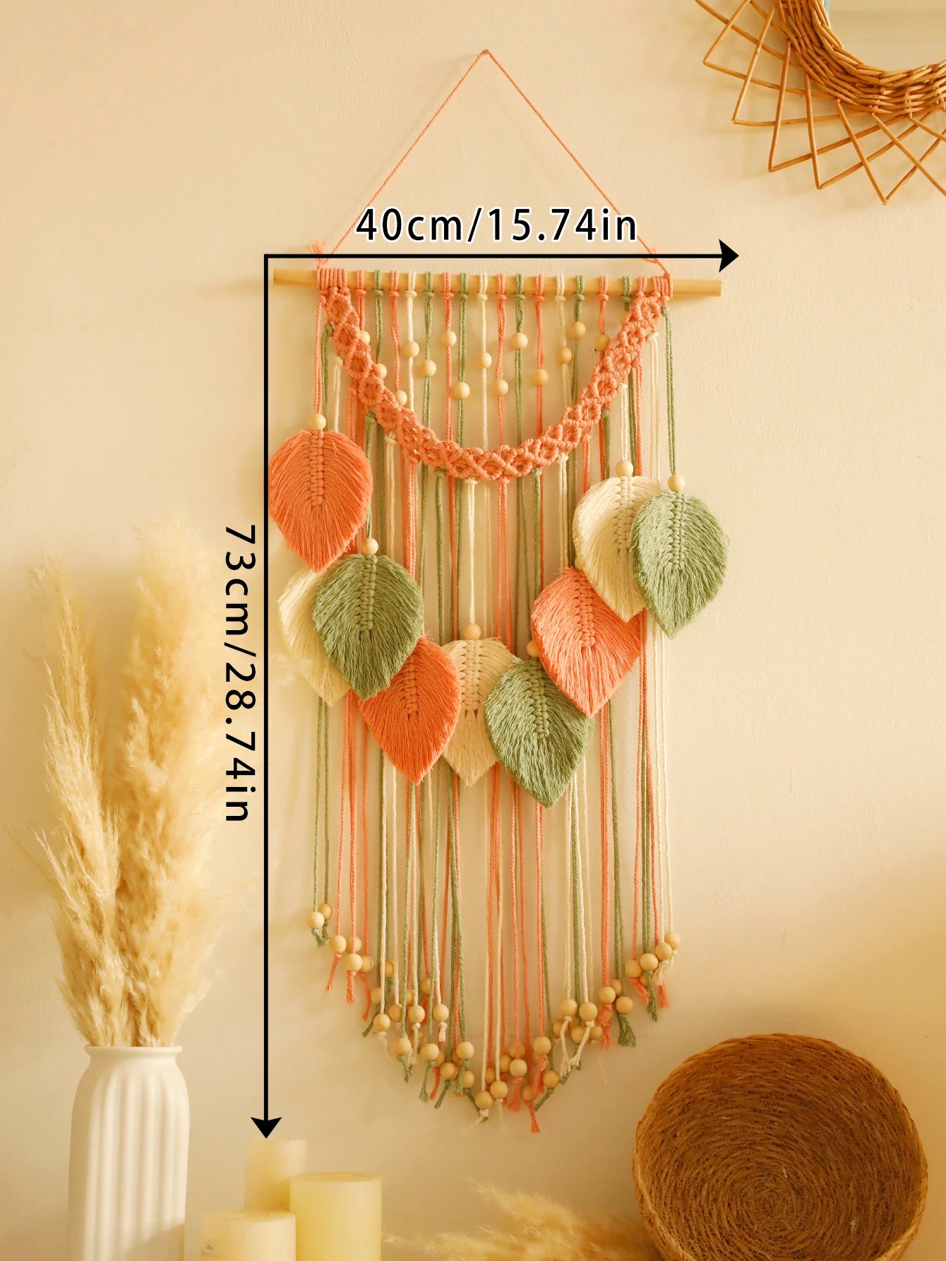 Decorative boho macrame wall hanging with knitted leaves and string, shown with measurements on a neutral background.
