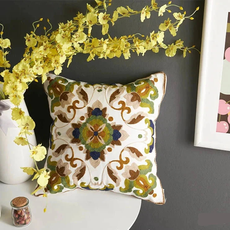 Decorative pillow with floral pattern on a dark wall with yellow flowers and a white table. floral embroidery on linen cotton cushion cover – boho home decor accent