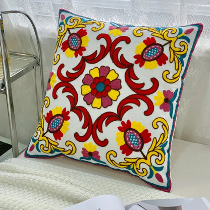 Decorative pillow with floral patterns on a white background, Handcrafted embroidered cushion cover on armchair – modern boho living room decor