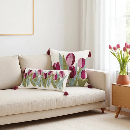 Decorative pillows with floral pattern on a beige sofa in a bright living room.