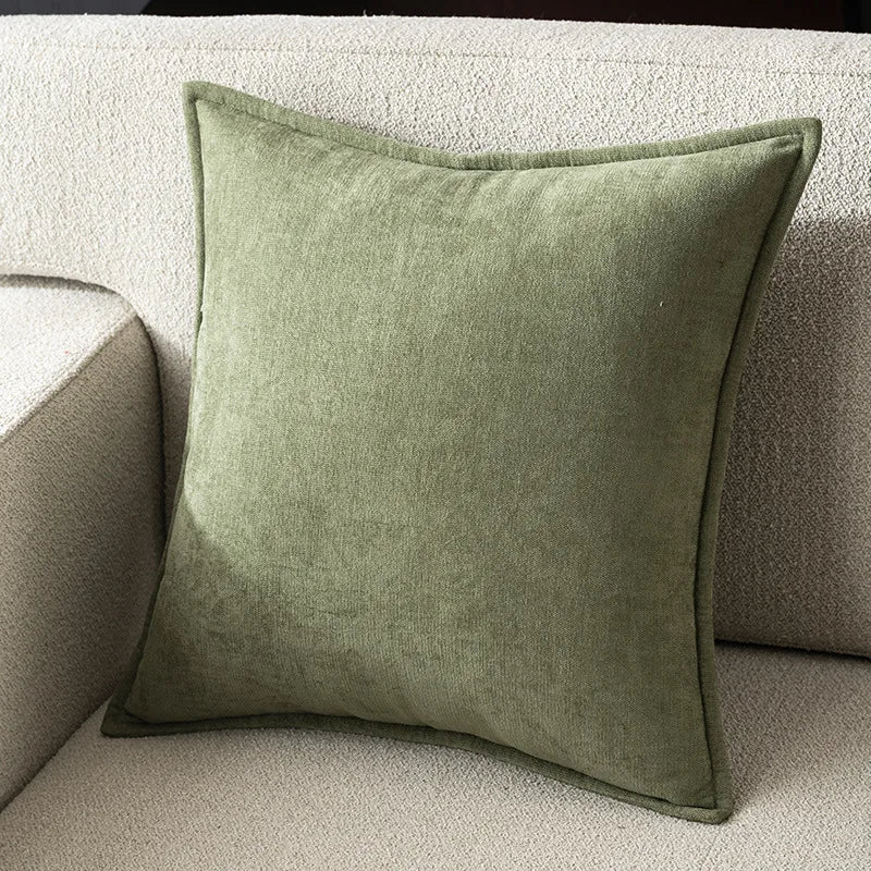 Green pillow on a beige sofa