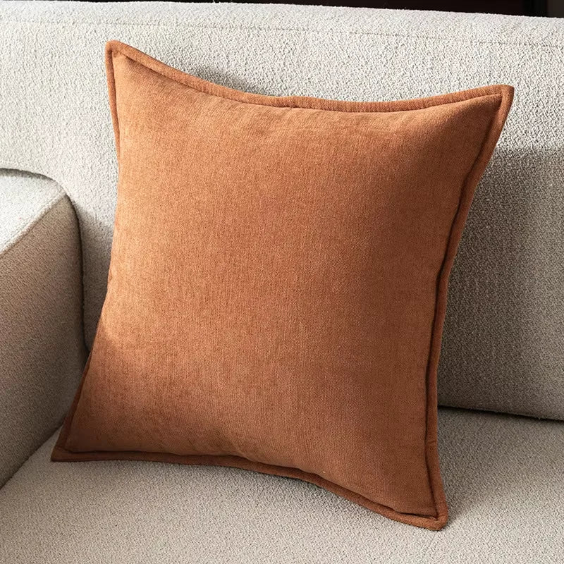 Brown pillow on a beige sofa