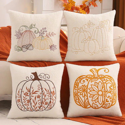 Four decorative pillows with pumpkin patterns on a couch. fall boho pillow throw gift ideas